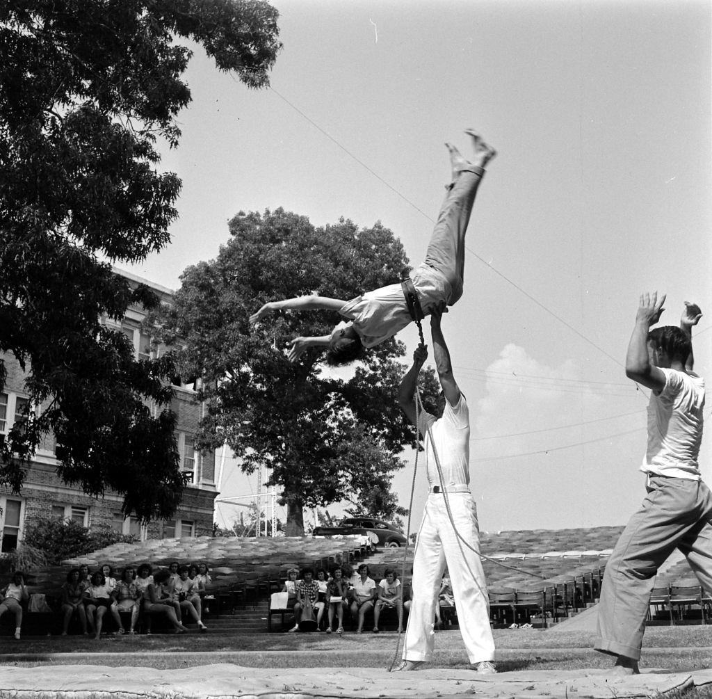 Cheerleader performing somersault at Sam Houston State Teachers College, Houston, 1950.