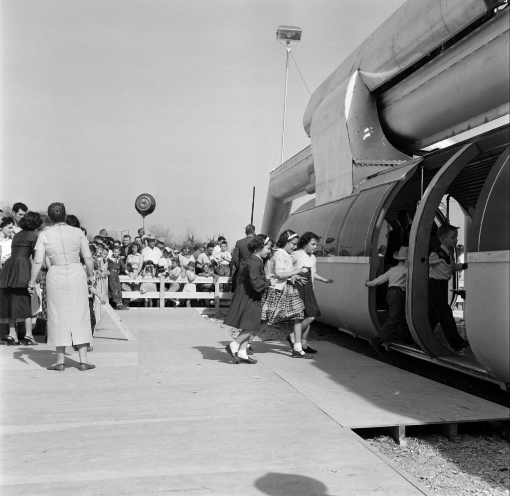 Children boarding a monorail train, Houston, Texas, February 1956