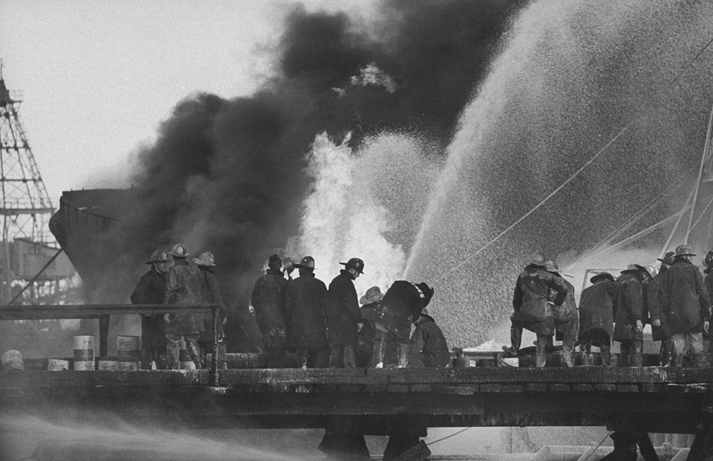 Fire fighters at tankers explosion in ship channel, 1959.