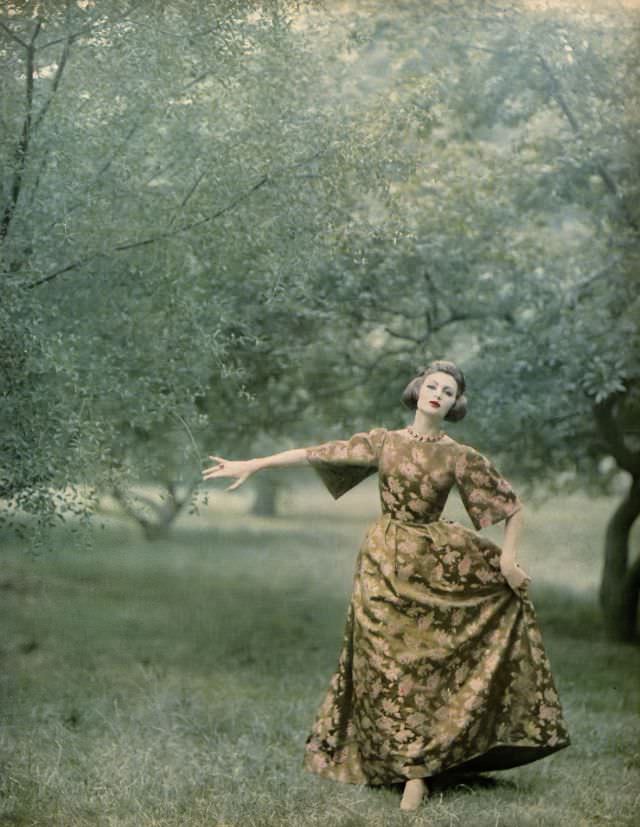 Isabella Albonico in brocade gown of gold and pink flowers on green background shot with gilt Lurex by Branell, coiffure by Elizabeth Arden. Harper's Bazaar, October 1959