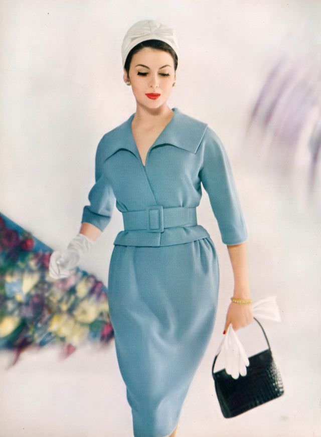 Isabella Albonico in pale blue wool and silk tweed suit with belted jacket by Monte Sano & Pruzan, white organdie hat by Irene of New York, jewelry by Cartier. Vogue, February 1, 1959