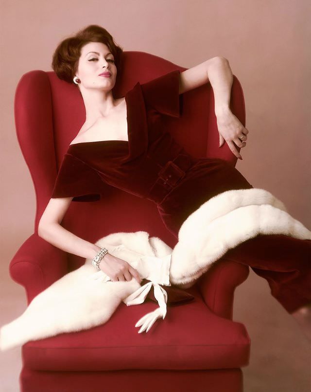 Isabella Albonico photographed by John Rawlings, wearing burgundy velvet dress by Harvey Berin with white mutation mink stole by Saga, 1959