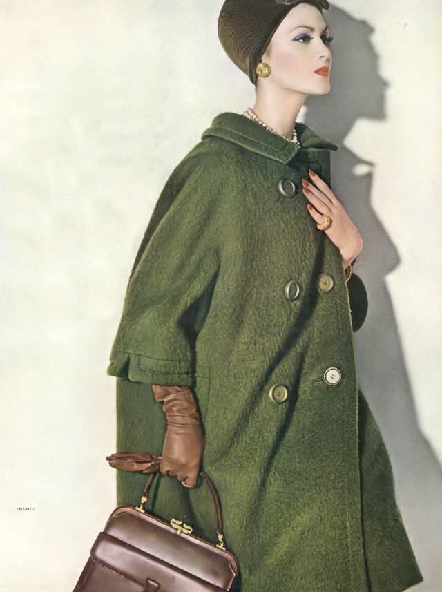 Isabella Albonico in moss-green shaggy wool coat with rounded shoulders and double-breasted by Christian Dior-New York, hat also by Dior-New York, handbag by Gucci. Vogue, August 15, 1960