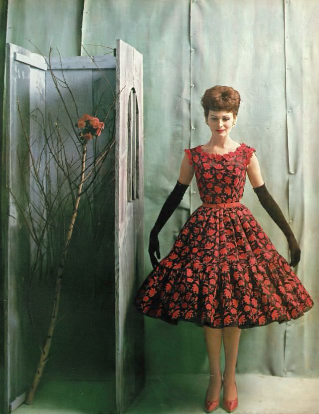 Isabella Albonico in ravishing late day dress of black Swiss organdie covered with red flowers by Traina-Norell. Harper's Bazaar, April 1960