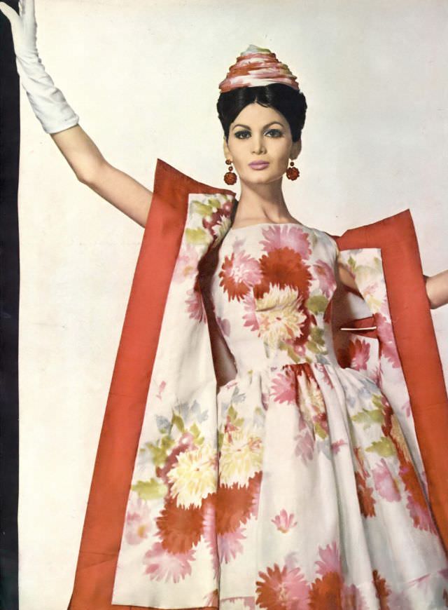 Isabella in beautiful short evening dress of silk organza printed in large daisies which spill over into the lining of the pink silk coat. Vogue, June 1, 1960