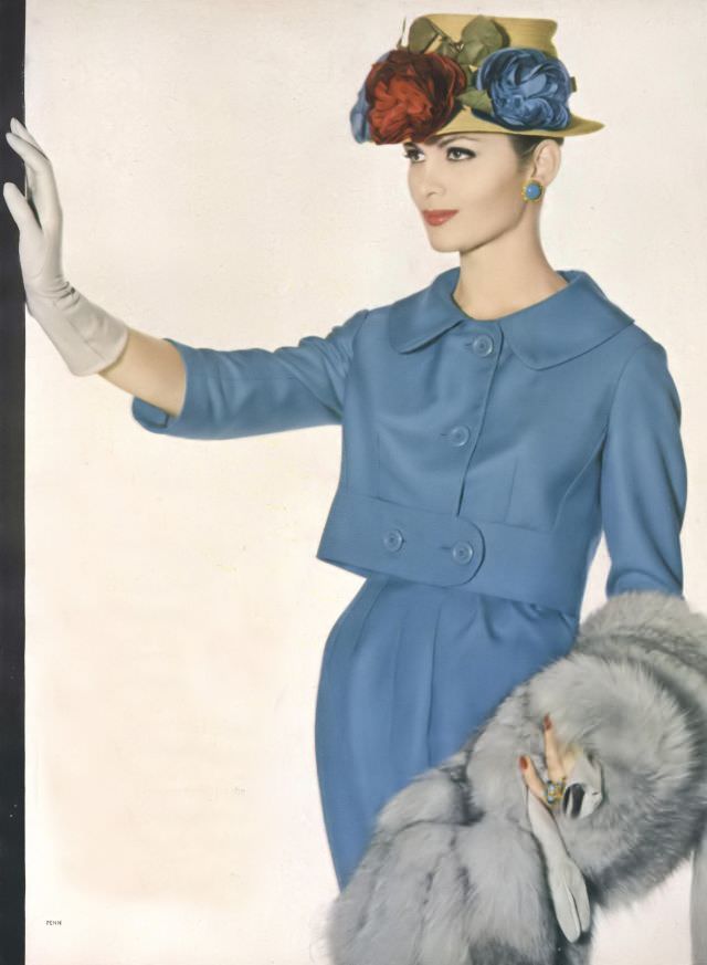 Isabella Albonico in beautiful blue suit of Italian silk twill by Marquise, SAGA Norwegian fox stole by Fredrica, silk flower hat by Emme. Vogue, March 1, 1959
