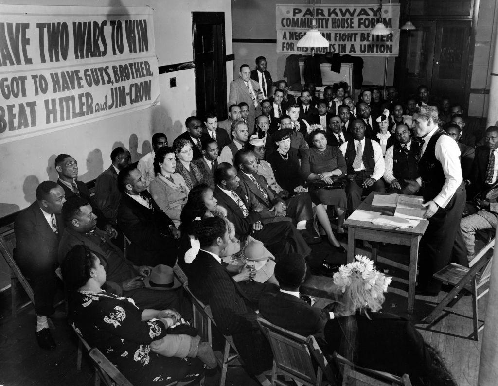 Group of mostly African Americans attending the Parkway Community House Forum re wartime rally to beat Hitler and Jim Crow laws, 1944.