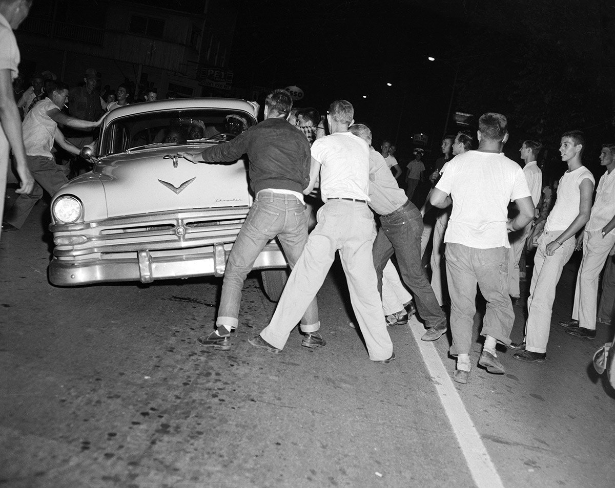 An unruly mob protesting integration of the Clinton High School attacks a car full of black people who just happened to be passing through on Aug. 31, 1956.