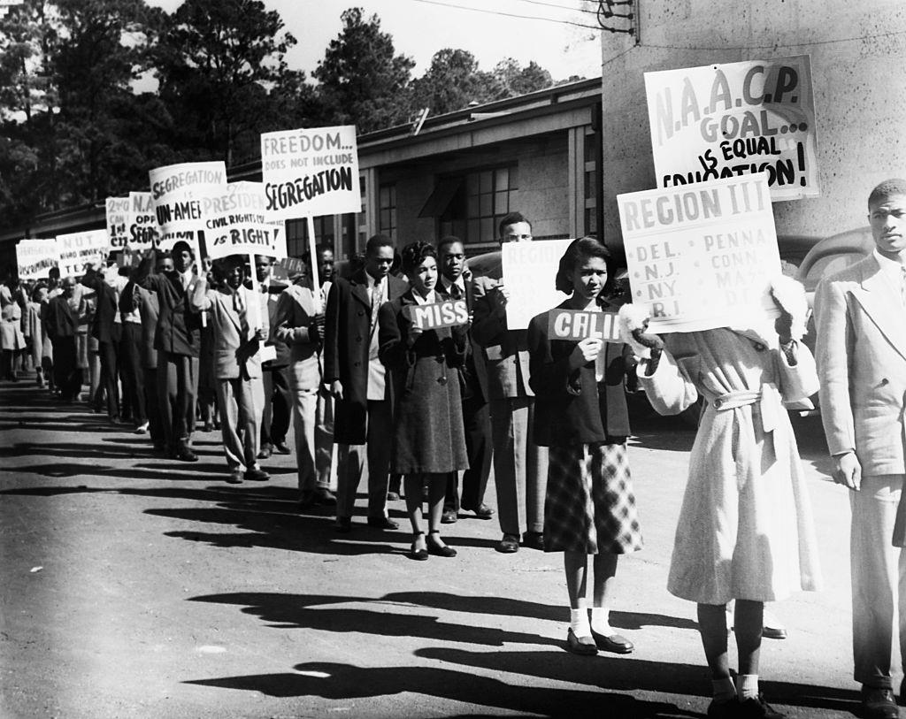 A line of African Americans hailing from states across the USA march to protest segregation. Ca. 1950.