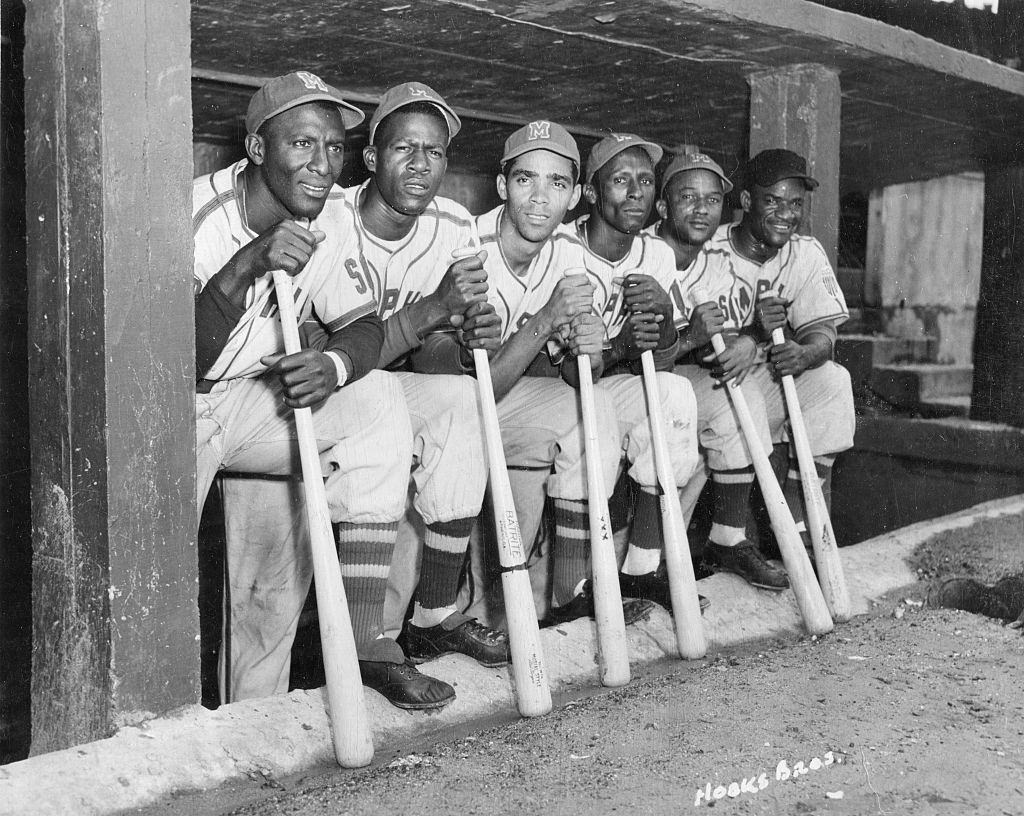A group of Cuban baseball players from the Negro League Red Sox in the dugout together during a home game, Memphis, Tennessee, circa 1951.