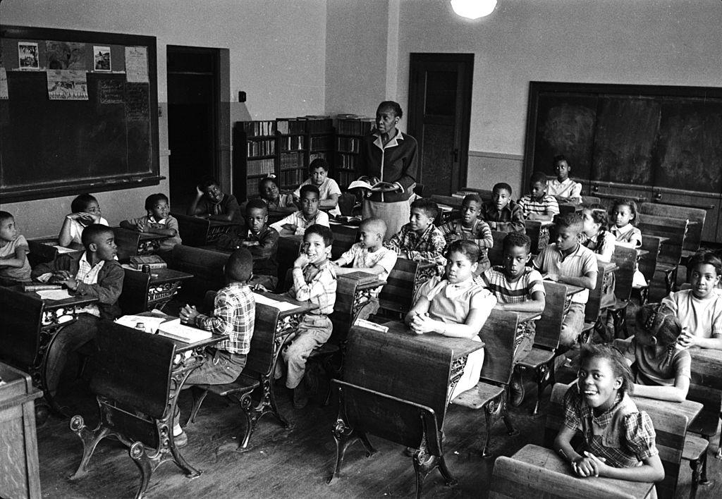 African-American student Linda Brown (first desk in second row from right) sits with her classmates at the racially segregated Monroe Elementary School, Topeka, Kansas, 1953.
