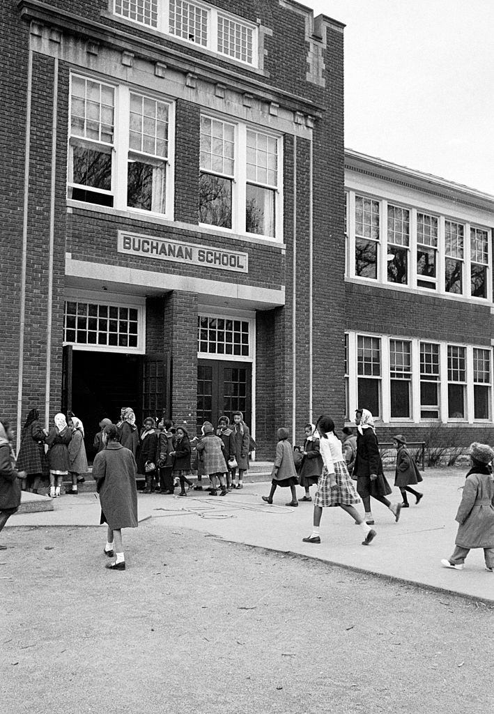 African American children arriving for class at the segregated Buchanan Elementary School, 1953.