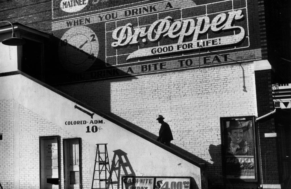 An African-American climbing up the stairs to the segregated section of a cinema in Belzoni, Mississippi, 1939.