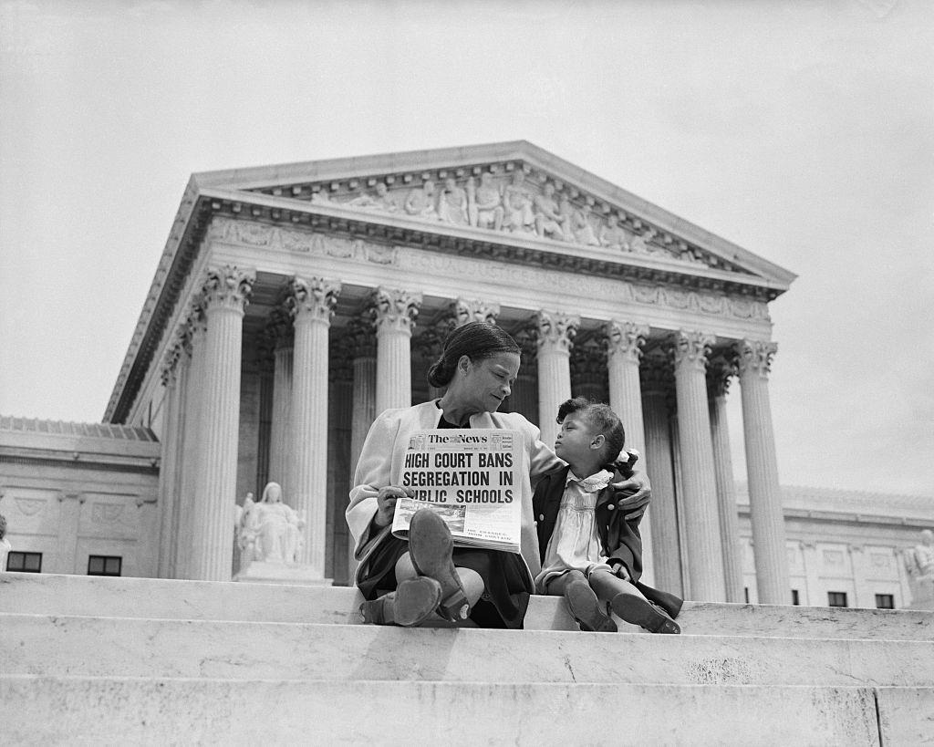 Nettie Hunt and her daughter Nickie sit on the steps of the U.S. Supreme Court, 1954.