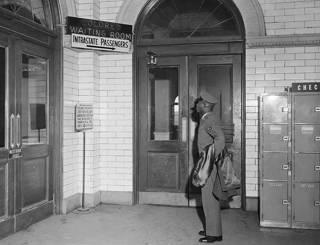African American Soldier Reads Segregated Terminal Sign, 1956.