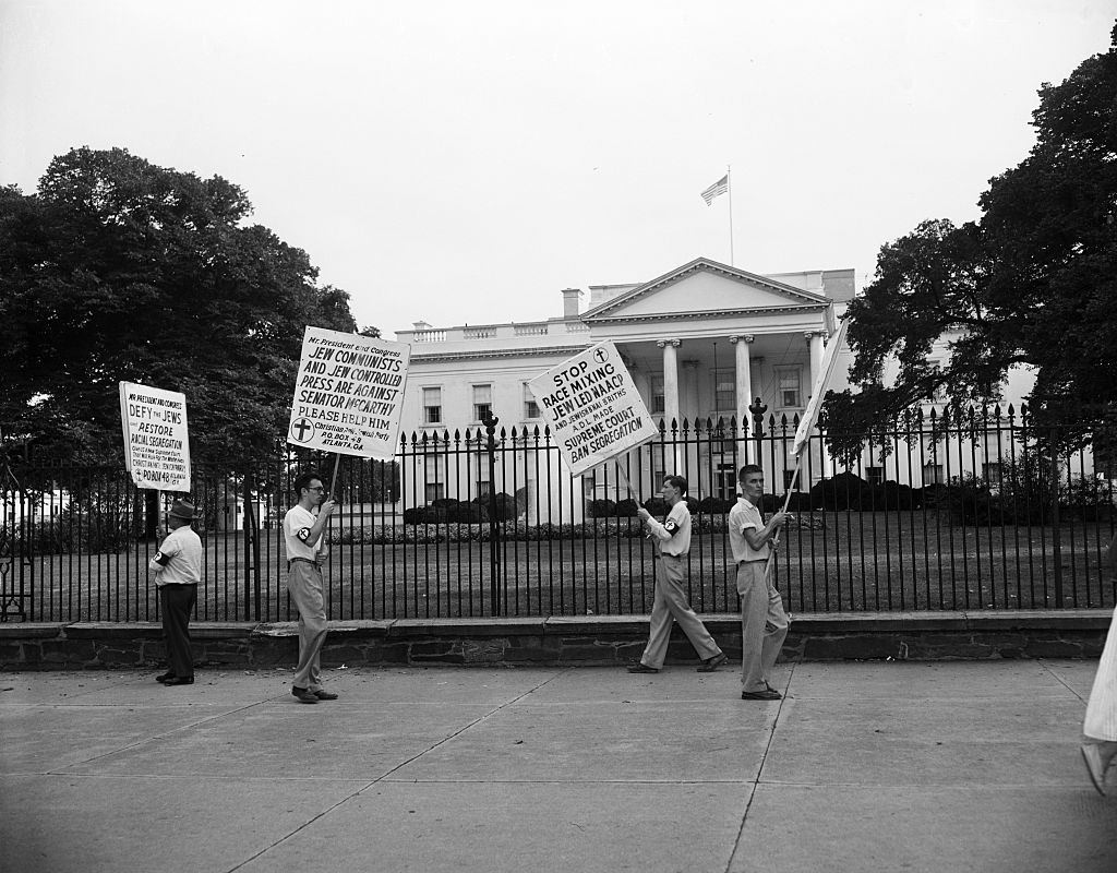 A group of individuals representing the Christian Anti-Jewish Party picketed the White House protesting the recent Supreme court decision against school racial segregation.