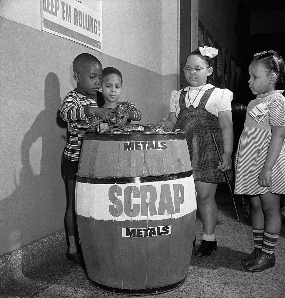 Children at a Negro grammar school adding to a scrap metal collection, 1942.