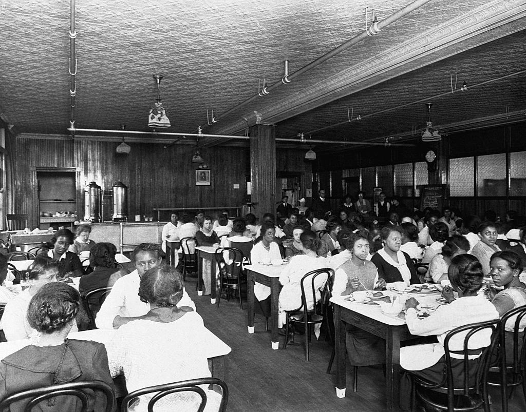African American workers eat in a segregated lunchroom at an American factory. Ca. 1930s.