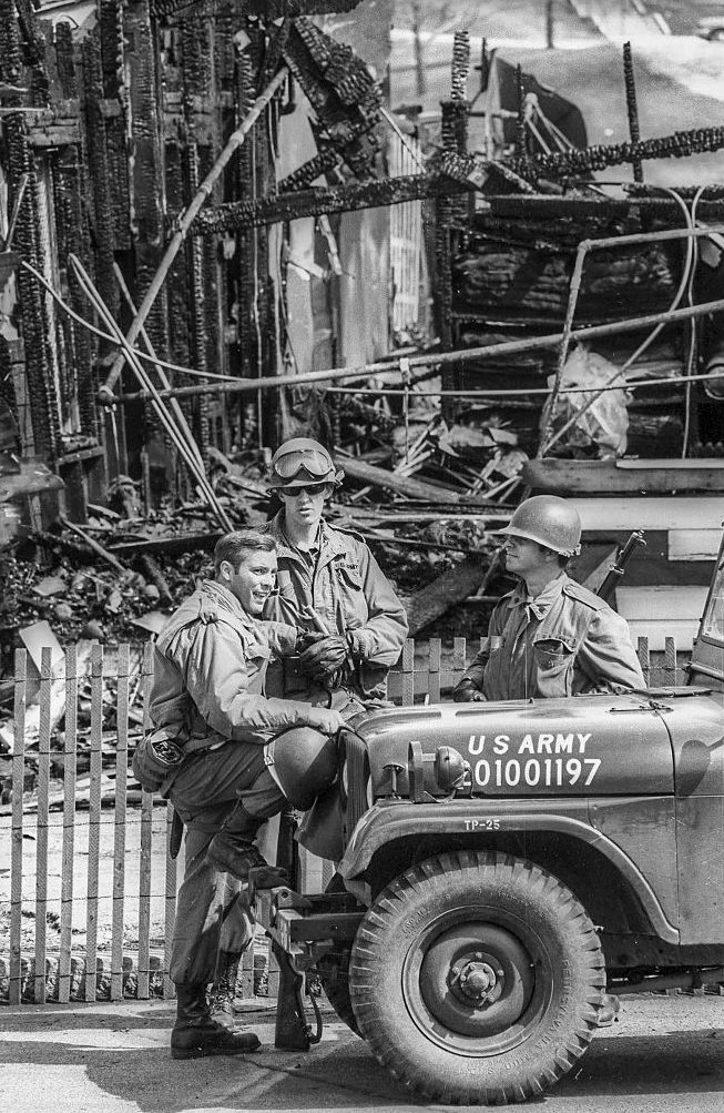 A trio of Ohio National Guardsmen as they stand by a jeep on the Kent State University campus, May 3, 1970.