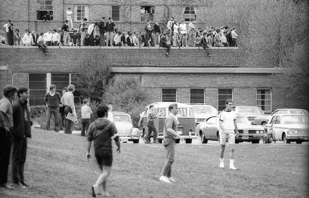 Kent State University students, some on the grass (in fore) and of an elevated plaza (in the background) look on the across the Commons during a student antiwar protest, Kent, Ohio, May 4, 1970.