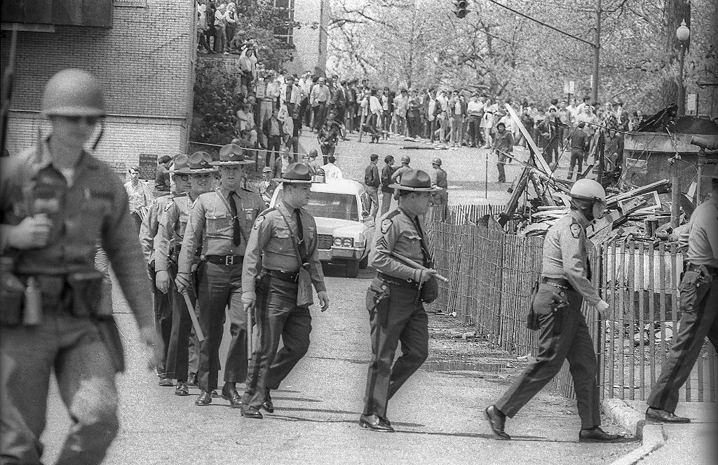 Ohio State Highway Patrol officers, with clubs in their hands, as they arrive at Kent State University.