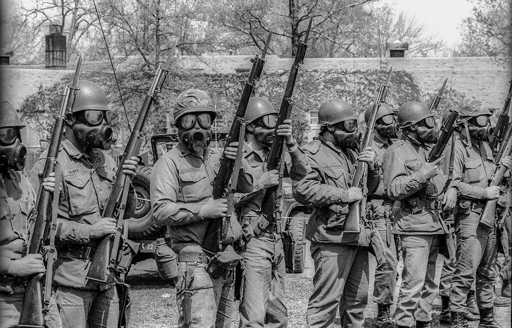 Ohio National Guardsmen, with rifles and gas masks, on the Kent State University campus, May 4th 1970.