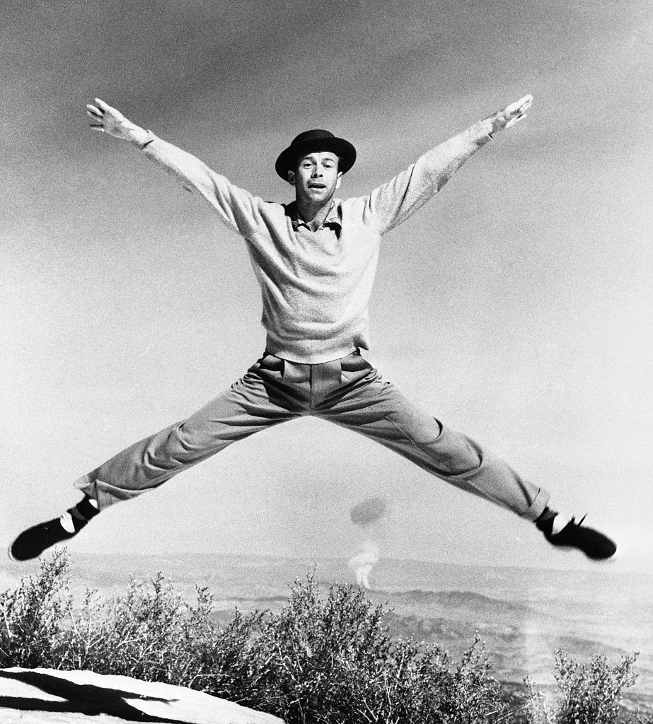 Dancer Gene Nelson throws himself in all directions as he performs what he calls the 'Atom Antic' on a mountain top not far from Las Vegas, 1952.