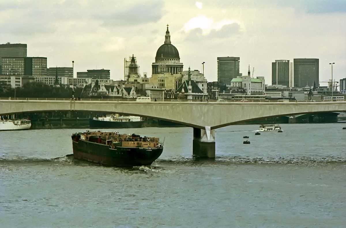 A barge passes beneath Waterloo Bridge on 19th April 1975