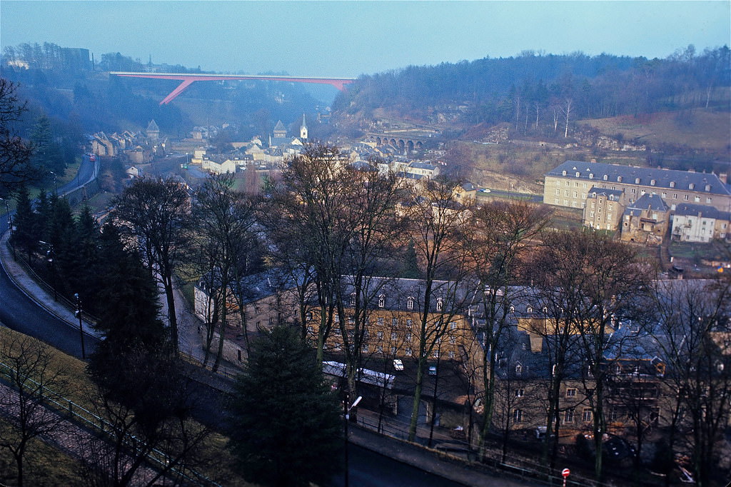 A global view of the lower district of Luxembourg-Pfaffenthal featuring the GD Charlotte Bridge, The Vauban Towers, The Vauban barracks and the Civil Hospita. Luxembourg City, Jan 1972