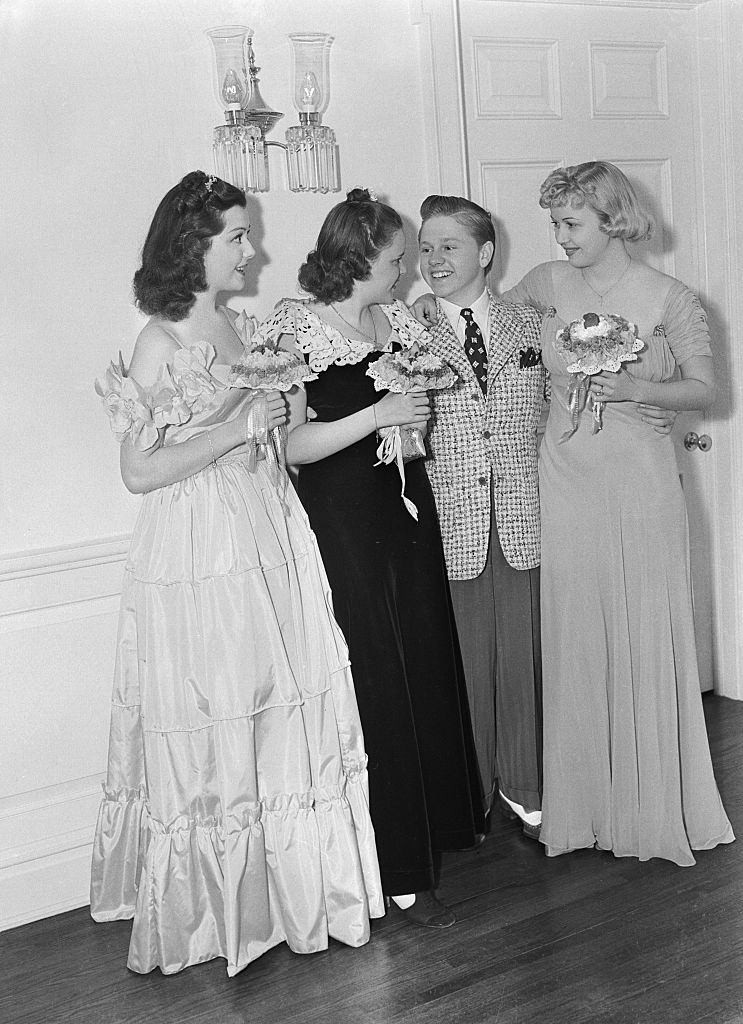 Mickey Rooney with Judy Garland, Ann Rutherford and Cecilia Parker at a production party.