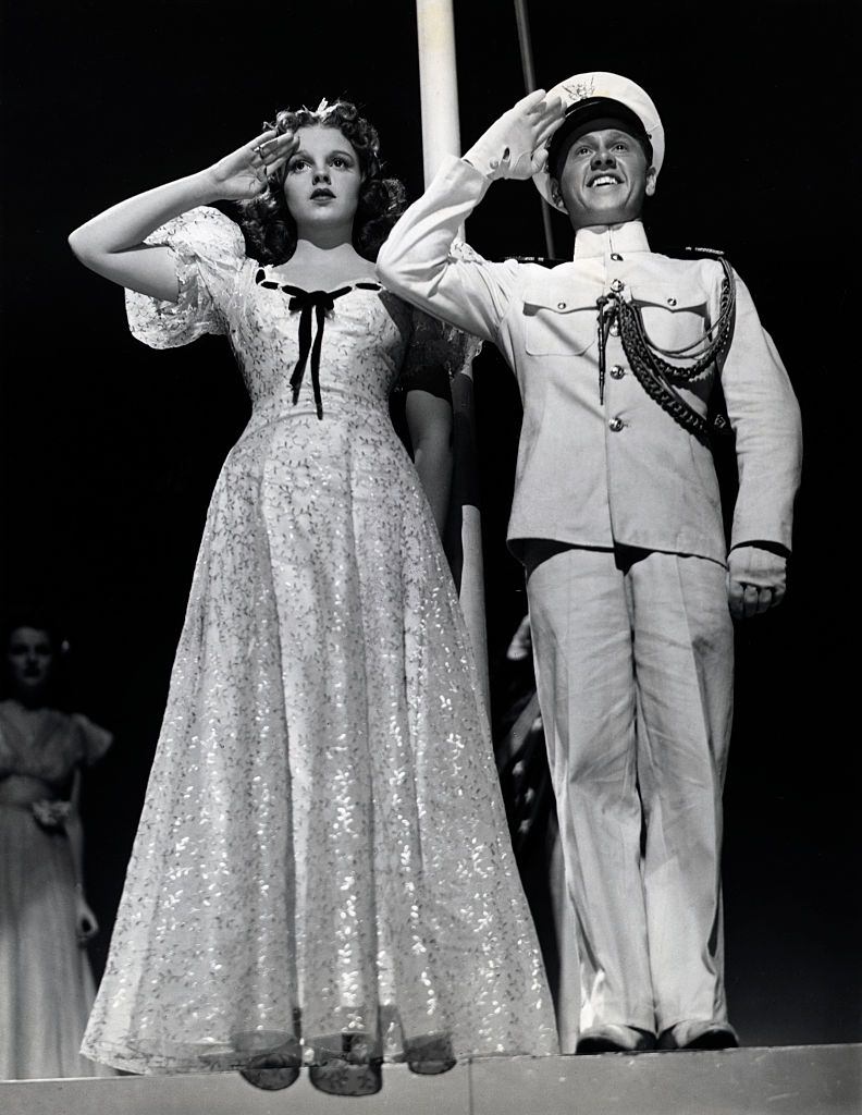 Mickey Rooney and Judy Garland saluting in the movie 'Strike up the Band', 1940s.