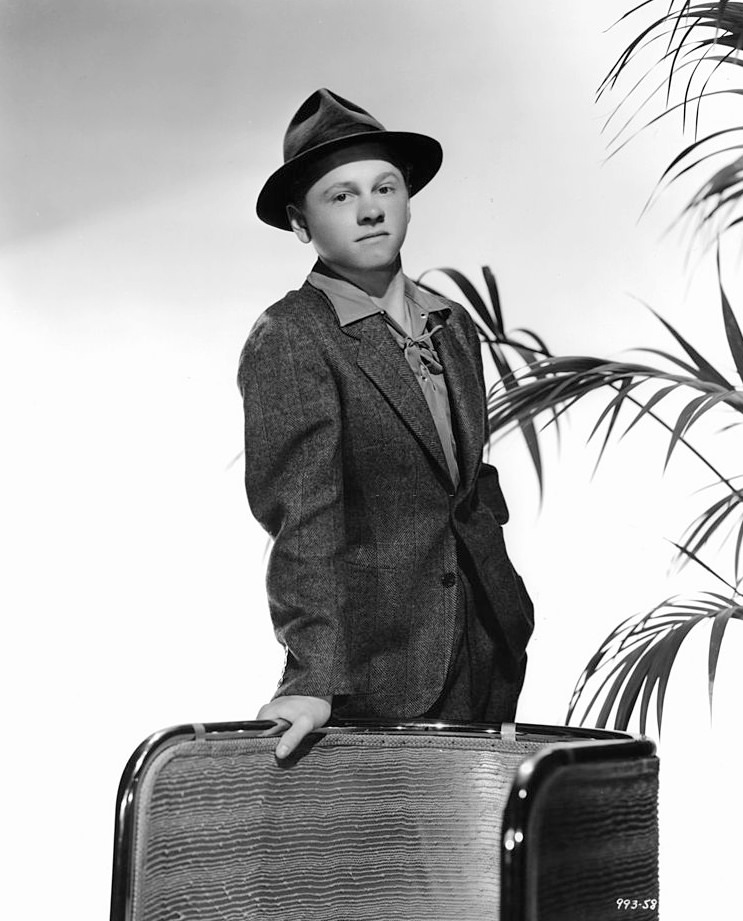 Mickey Rooney leaning against chair in a promotional portrait for the film 'A Family Affair', 1937.