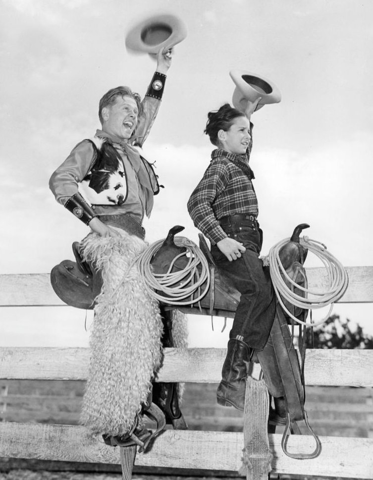 Mickey Rooney rides the fence with Virginia Weidler in a scene from the film 'Out West With The Hardys', 1946.