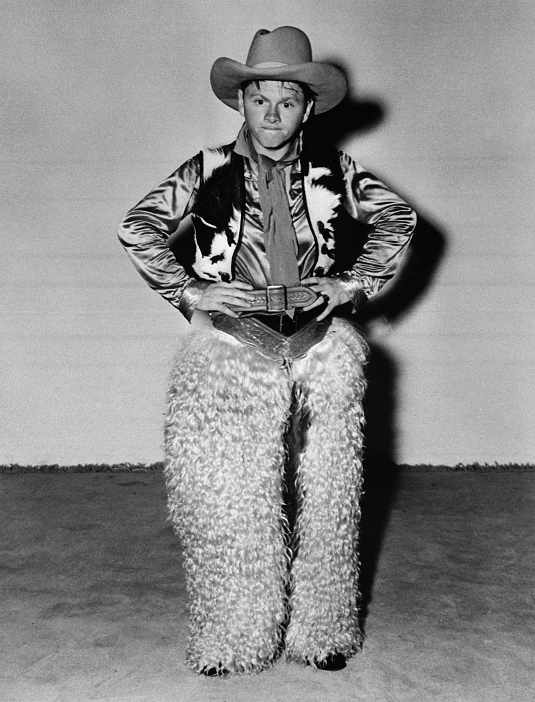 Mickey Ronney posing in a cowboy costume.