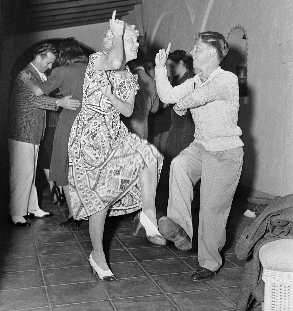 Mickey Rooney Rescues Nancy Carroll, 1939.Mickey Rooney dancing with her mother at a party