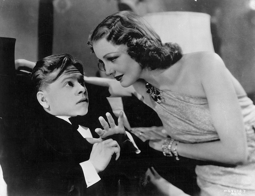 Mickey Rooney is reclined as Virginia Grey leaning into him in a scene from the film 'The Hardys Ride High', 1939.