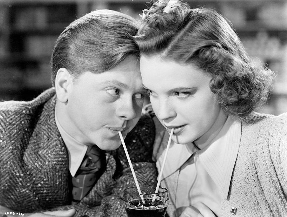 Mickey Rooney and Judy Garland sharing a soda in a scene from the film 'Babes In Arms', 1939.