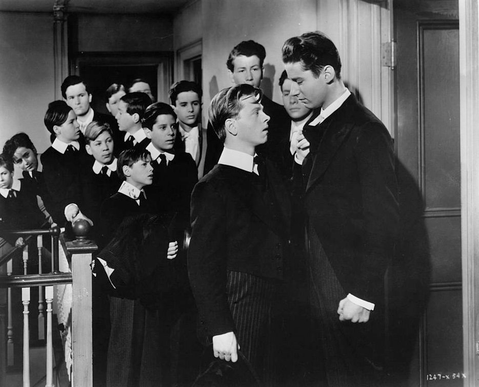 Mickey Rooney pulls on the collar of Peter Lawford in a scene from the film 'A Yank At Eton', 1942.