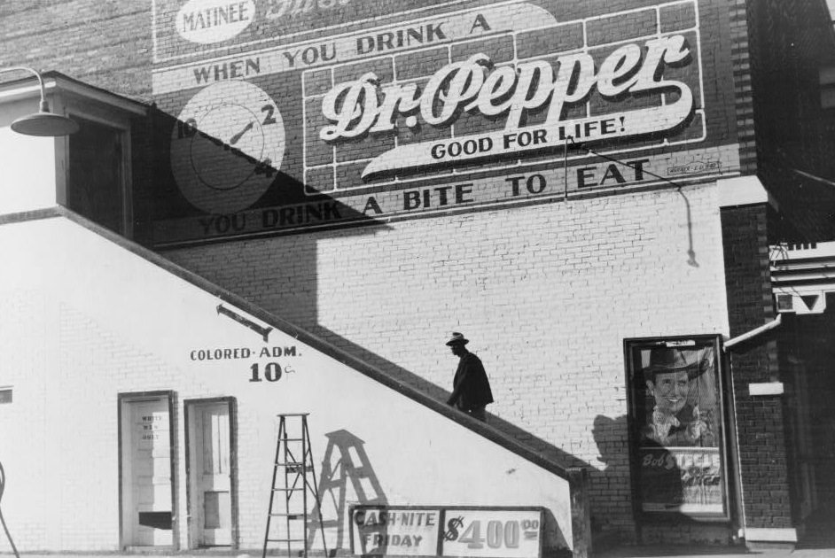 Going in the ‘colored’ entrance of a movie house on Saturday afternoon, Belzoni, Mississippi Delta, Mississippi. November 1939