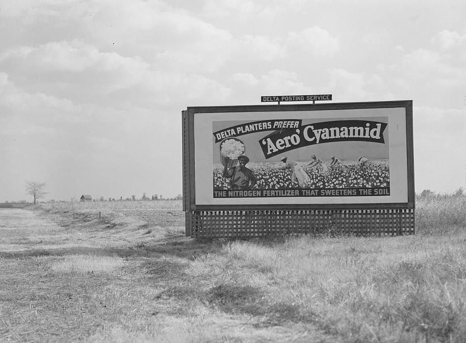 Billboard advertising fertilizer dusted over the cotton fields by aeroplanes. Mississippi Delta, October 1939