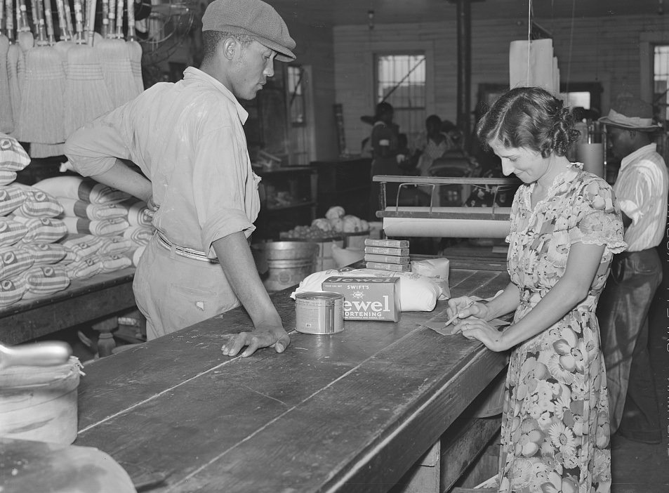 Wagehand purchasing groceries after being paid off on Saturday in plantation store. Mileston Plantation. Mississippi Delta, November 1939