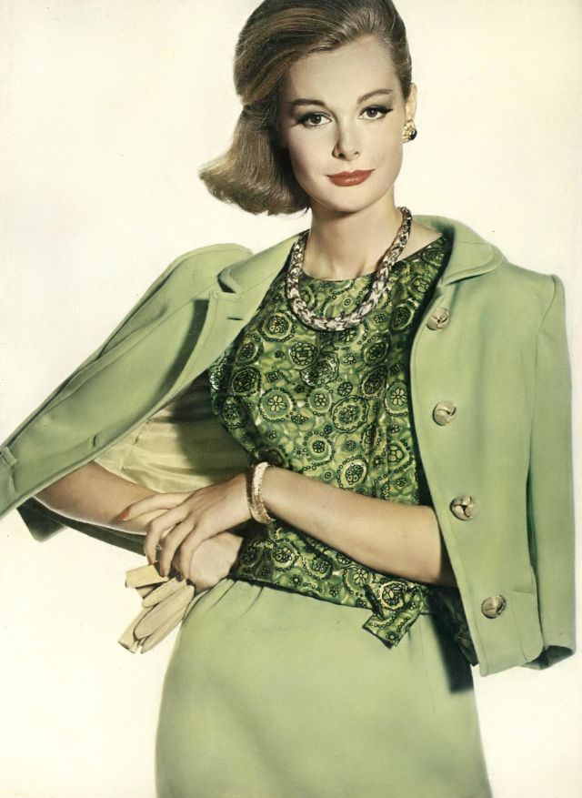 Monique Chevalier in almond-green wool jersey suit with sleeveless silk paisley blouse, Vogue. December 1, 1961