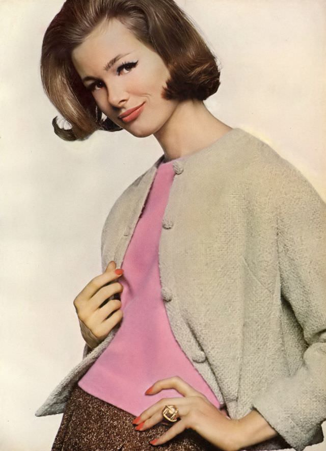 Monique Chevalier in cinnamon skirt and blond cardigan of wool tweed over pink sleeveless angora and lambswool pull-over, Vogue. August 1, 1961
