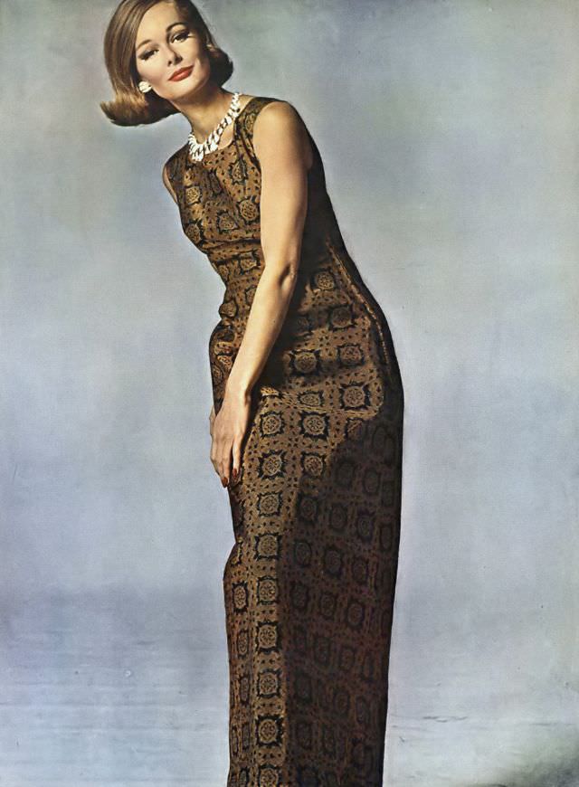 Monique Chevalier in long sheath of bronze silk, tile-printed in black, Vogue. May 1, 1962