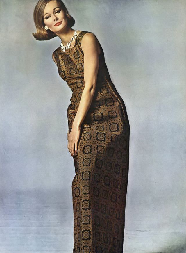 Monique Chevalier in long sheath of bronze silk, tile-printed in black, Vogue. May 1, 1962
