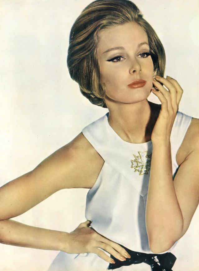 Monique Chevalier in pure white short, full-skirted dress of silk crêpe, Vogue. May 1, 1962