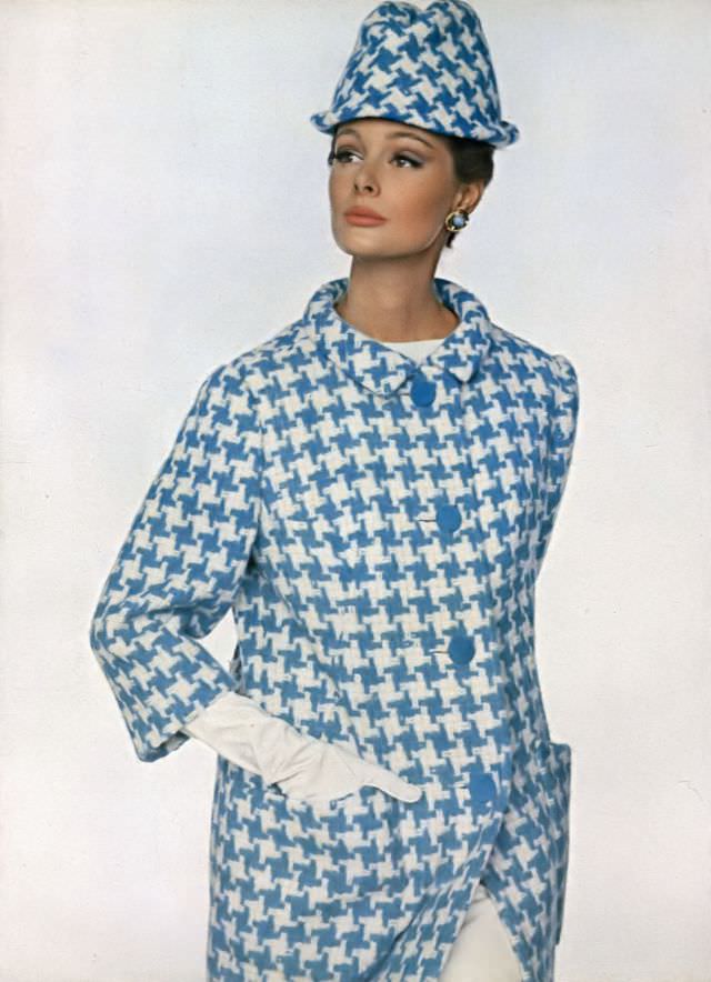 Monique Chevalier in slim coat of blue and white wool houndstooth, Vogue. January 1, 1963