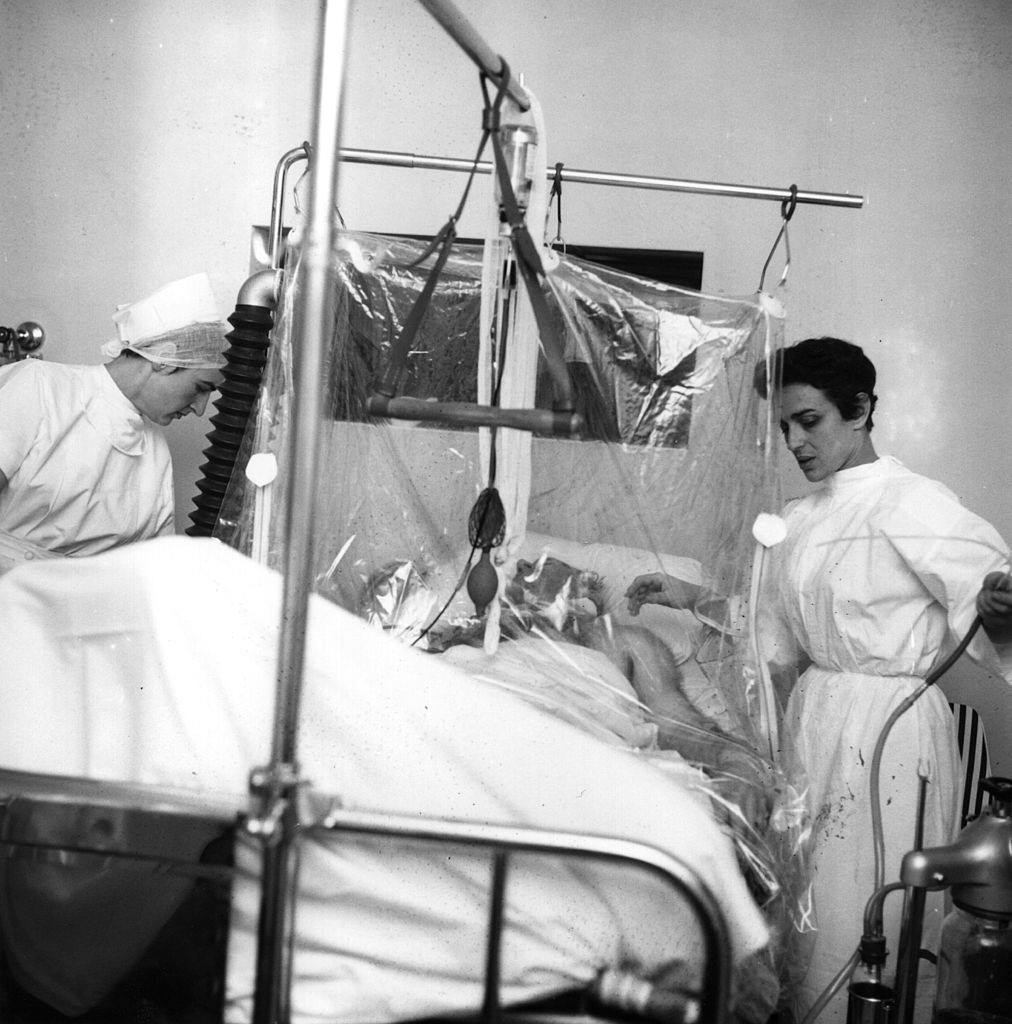 Sir Matt Busby (1909 - 1994), football manager of Manchester United, lying in hospital in an oxygen tent after the Munich air crash, 13th Feb 1958.