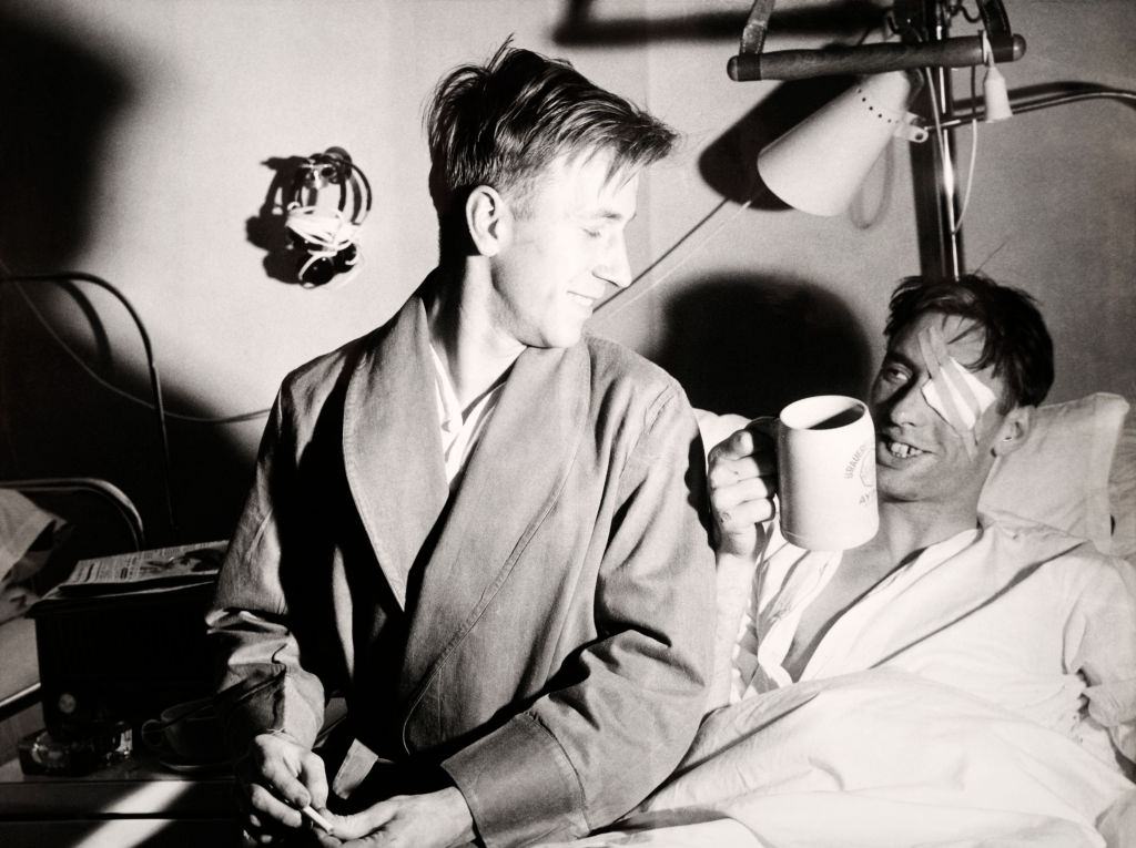 Manchester United survivor Ray Wood in hospital with his teammate Bobby Charlton (left) following the Munich Air Disaster.