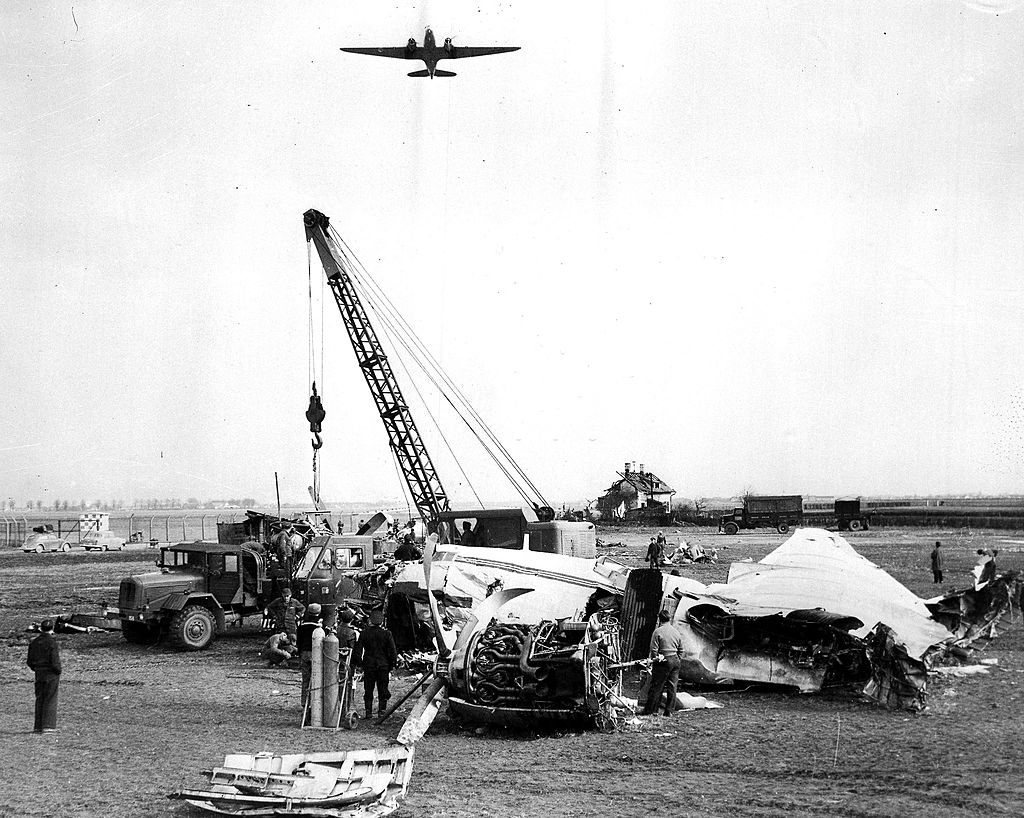 A crane removing the wreckage of the BEA Elizabethan airliner G-ALZU 'Lord Burghley' from Reim airport, Munich. 16th February 1958